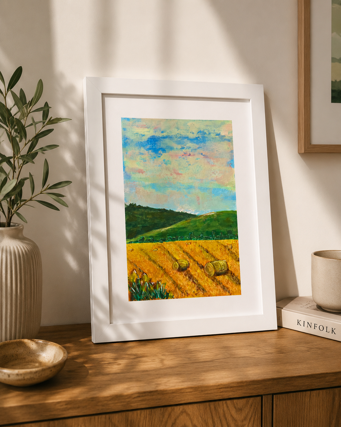 Hay Bales Acrylic Art in a white frame on a shelf in home