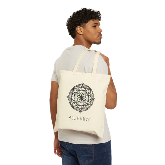 Man carrying a tote bag with mandala pattern and Allie & Joy logo below on a white background